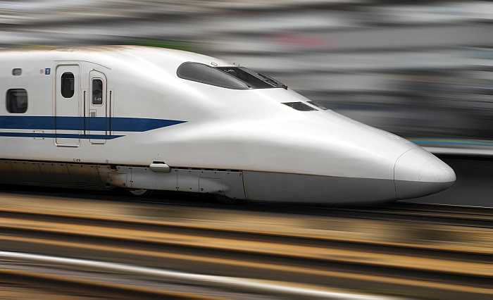 Bullet train speeding through railway station in Tokyo, Japan.