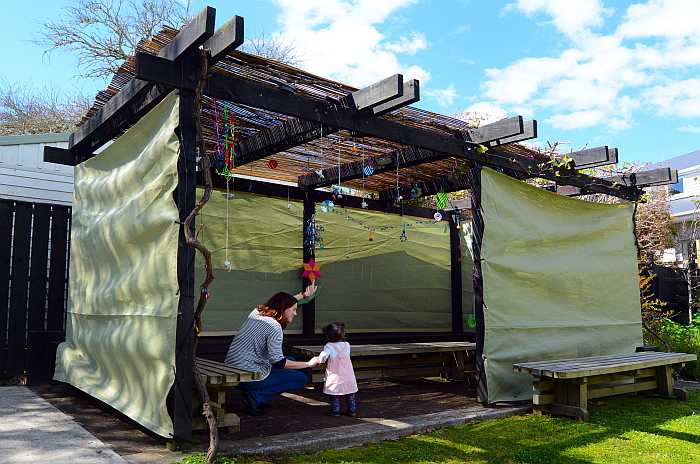 Family visiting decorated sukkah or hut that Jews eat in during the holiday of Sukkot.