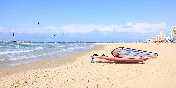 Kite surfing on the beach in Tel Aviv, Israel.